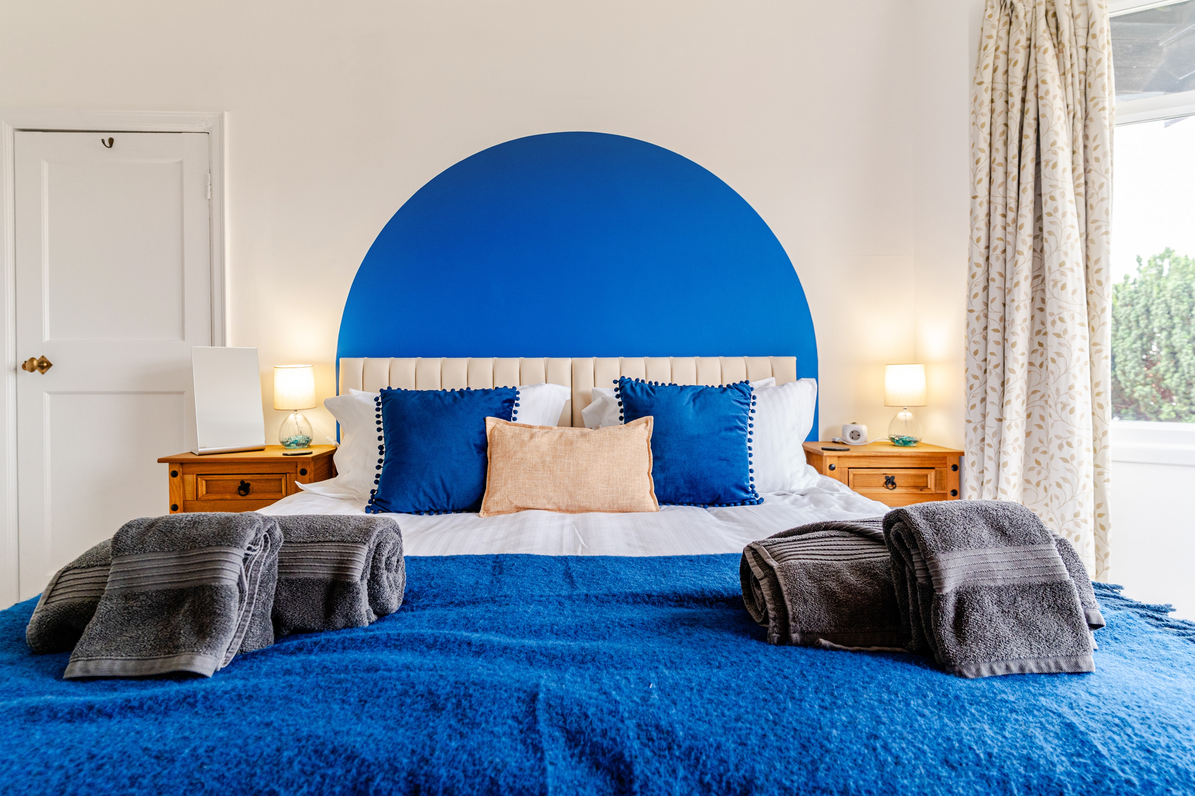 Bedroom 1 featuring the blue arched headboard