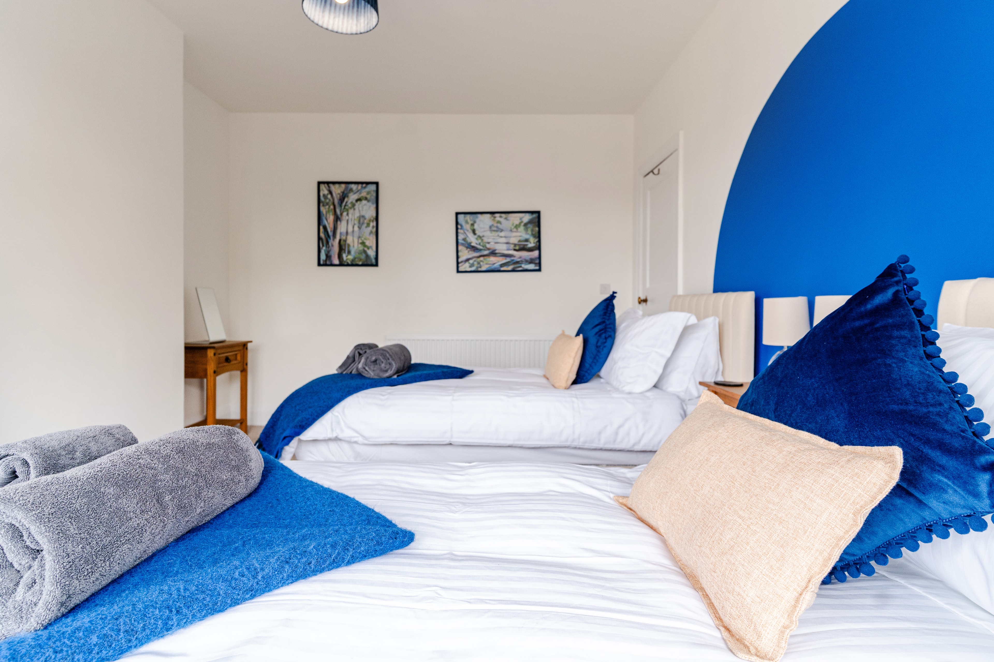Bedroom 1 twin beds with wall artwork