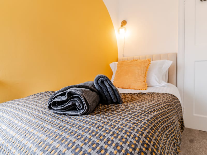 Bedroom 3 — single bed with towels